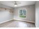 Bedroom with a large window overlooking an outdoor view and ceiling fan at 1639 Yellow Brick Rd, Astor, FL 32102