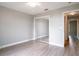 Bedroom with neutral walls, ceiling fan, wood flooring, and mirrored closet at 1639 Yellow Brick Rd, Astor, FL 32102