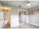 Bedroom with a mirrored closet, ceiling fan, and wood shelving on the walls at 1639 Yellow Brick Rd, Astor, FL 32102