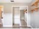 Bedroom with a mirrored closet, wood flooring, ceiling fan, and wood shelving at 1639 Yellow Brick Rd, Astor, FL 32102