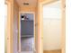 Hallway view from bedroom to bathroom and closet with tile flooring and neutral paint at 1639 Yellow Brick Rd, Astor, FL 32102