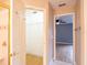 Hallway view to bathroom and closet with tile flooring and neutral paint at 1639 Yellow Brick Rd, Astor, FL 32102