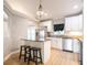Kitchen with white cabinets, stainless steel appliances, and a breakfast bar with seating at 1639 Yellow Brick Rd, Astor, FL 32102