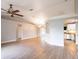 Open-concept living area with wood floors and neutral paint, leading into the kitchen at 1639 Yellow Brick Rd, Astor, FL 32102