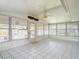 Inviting sunroom with large windows, tile flooring, and ceiling fan, perfect for relaxing at 1639 Yellow Brick Rd, Astor, FL 32102