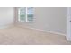 Bright bedroom featuring two windows, neutral walls and carpet, and white baseboards at 1978 J Lawson Blvd, Orlando, FL 32824