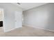 Bedroom with neutral walls, carpet, white door, and view into the Primary bath at 1978 J Lawson Blvd, Orlando, FL 32824