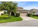 Charming home featuring a two-car garage, well-maintained lawn, and beautiful landscaping at 1978 J Lawson Blvd, Orlando, FL 32824