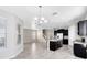 Open-concept kitchen featuring a central island, stainless steel appliances, and elegant black cabinetry at 1978 J Lawson Blvd, Orlando, FL 32824