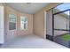 Enclosed lanai featuring beige walls, neutral flooring, and windows offering ample light at 1978 J Lawson Blvd, Orlando, FL 32824