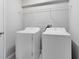 Functional laundry room featuring a washer, dryer, and practical storage shelves, streamlining household tasks at 1978 J Lawson Blvd, Orlando, FL 32824