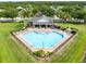 Stunning aerial view of the community pool with spacious lounge area, clubhouse, and lush landscaping at 1978 J Lawson Blvd, Orlando, FL 32824