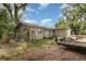 Backyard featuring a trailer, trees, miscellaneous tools, and a fenced perimeter at 205 W Division St, Deland, FL 32720