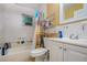 Modest bathroom featuring a white toilet, tub/shower combo with curtain, and vanity with sink at 205 W Division St, Deland, FL 32720