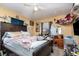 Bedroom features a ceiling fan, a small window, and a large desk and wall mounted tv at 205 W Division St, Deland, FL 32720