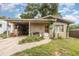 Charming single-story home with a covered carport and a neatly maintained front yard at 205 W Division St, Deland, FL 32720