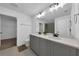 Modern bathroom with double vanity, white quartz counters, and a large, well lit mirror at 2210 Derwent Dr, Davenport, FL 33896