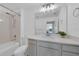 Clean bathroom with a tub, shower, and vanity with bright mirror and modern lighting at 2210 Derwent Dr, Davenport, FL 33896