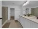 Bright bathroom with double vanity, walk-in shower, and access to a walk-in closet at 2210 Derwent Dr, Davenport, FL 33896