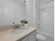 Bright bathroom features a shower-tub combo, modern fixtures, and a stylish vanity with stone counters at 2210 Derwent Dr, Davenport, FL 33896