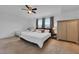 Bright bedroom with two beds, a ceiling fan, and large windows that offer pleasant natural light at 2210 Derwent Dr, Davenport, FL 33896
