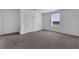 Spacious bedroom featuring neutral carpeting, a large window, and a closet for storage at 2210 Derwent Dr, Davenport, FL 33896