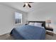 Cozy bedroom with a ceiling fan, large window, and a comfortable blue quilt at 2210 Derwent Dr, Davenport, FL 33896