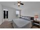 This bedroom has a ceiling fan, a large window, and comfortable furnishings at 2210 Derwent Dr, Davenport, FL 33896