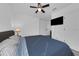 This cozy bedroom includes a comfortable bed, mounted television, ceiling fan, and natural light at 2210 Derwent Dr, Davenport, FL 33896