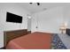 Spacious bedroom with a bed, dresser, TV, and two windows with blinds at 2210 Derwent Dr, Davenport, FL 33896