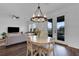 A stylish dining area boasts a chandelier, table, and access to the outdoors, ideal for entertaining guests at 2210 Derwent Dr, Davenport, FL 33896