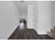 Hallway with dark wood flooring leading to the living room and stairs to the right at 2210 Derwent Dr, Davenport, FL 33896