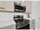 Modern kitchen featuring stainless steel appliances, white subway tile backsplash, and quartz countertops at 2210 Derwent Dr, Davenport, FL 33896