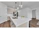 Kitchen island with a quartz countertop, pendant lighting, and a stainless steel refrigerator at 2210 Derwent Dr, Davenport, FL 33896