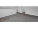 Open living room with gray carpet, white trim, and easy access to multiple rooms at 2210 Derwent Dr, Davenport, FL 33896