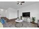A modern living room with comfortable seating, neutral tones, and a TV, perfect for relaxation and entertainment at 2210 Derwent Dr, Davenport, FL 33896