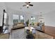 Open-concept living space with stylish furniture, a modern TV, and easy access to the kitchen and dining area at 2210 Derwent Dr, Davenport, FL 33896