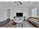 Relax in this cozy living room with stylish furniture, a modern TV, and plenty of natural light at 2210 Derwent Dr, Davenport, FL 33896