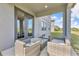 This covered patio features comfortable seating and a glass table at 2210 Derwent Dr, Davenport, FL 33896