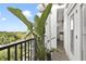 Beautiful balcony with black railings, tile floors, white pillars, and tree-top views at 2305 Edgewater Dr # 1613, Orlando, FL 32804