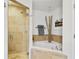 Bright bathroom featuring a tiled shower, garden tub, and spa-like accents at 2305 Edgewater Dr # 1613, Orlando, FL 32804