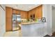 Well-lit kitchen with stainless steel appliances, granite countertops, and light wood cabinets at 2305 Edgewater Dr # 1613, Orlando, FL 32804