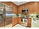 Well-lit kitchen featuring stainless steel appliances and granite countertops at 2305 Edgewater Dr # 1613, Orlando, FL 32804