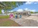 Backyard featuring a trampoline, swing set, patio furniture, and screened-in porch, providing a perfect space for outdoor relaxation at 2312 Poinciana Rd, Winter Park, FL 32792