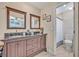 Bathroom with a double sink vanity, dark wood cabinets, granite counters, and a separate toilet room at 2312 Poinciana Rd, Winter Park, FL 32792