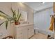 Bright bathroom featuring a white vanity with marble countertop, framed mirror, and a shower with clear door at 2312 Poinciana Rd, Winter Park, FL 32792