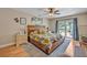 Spacious bedroom featuring a large bed with floral bedding and sliding glass doors to the backyard at 2312 Poinciana Rd, Winter Park, FL 32792