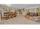 Open dining room with wood table and view of the living room and kitchen at 2312 Poinciana Rd, Winter Park, FL 32792