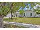 Charming single-story home boasts a well-manicured lawn, beautiful landscaping, and a welcoming front entrance at 2312 Poinciana Rd, Winter Park, FL 32792