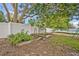 Vegetable garden featuring a wooden fence, lush greenery, and mature trees, offering a serene outdoor space at 2312 Poinciana Rd, Winter Park, FL 32792